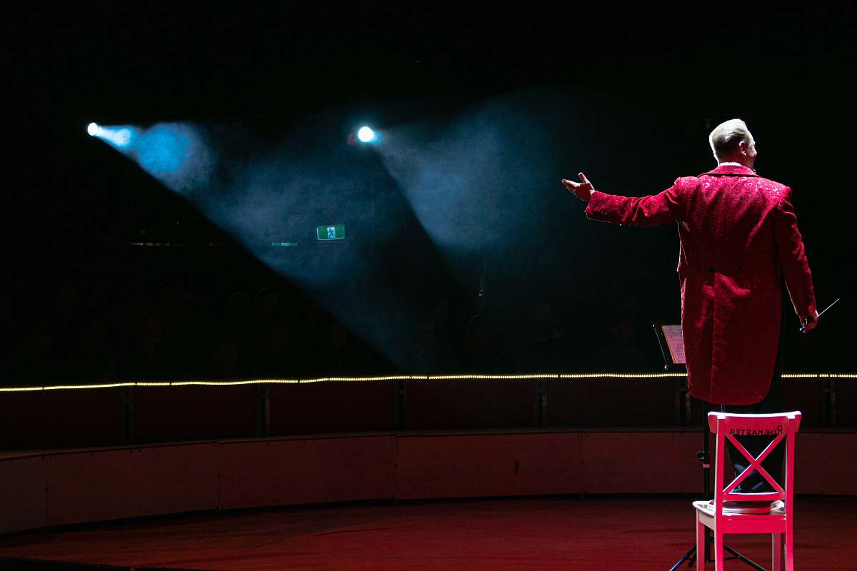 interior design man in red coat stage